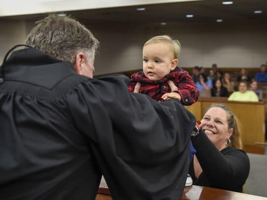 Circuit Judge Duane Slone reaches to pick up 1-year-old Gabriel from his mother, Margo Azbill, 37, during her court visit Thursday, Jan. 19, 2017, in Dandridge, Tenn. Azbill has been in recovery court and clean for 16 months after using opioids for 22 years. (Photo: Lacy Atkins / The Tennessean)