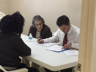 Volunteer attorneys Bo Burk and Mary Mayham helping a client.