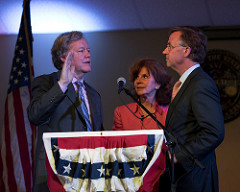 Justice Roger A. Page receives the oath of office from Gov. Bill Haslam. Justice Page's wife. Davidson County Chancellor Carol McCoy, looks on.