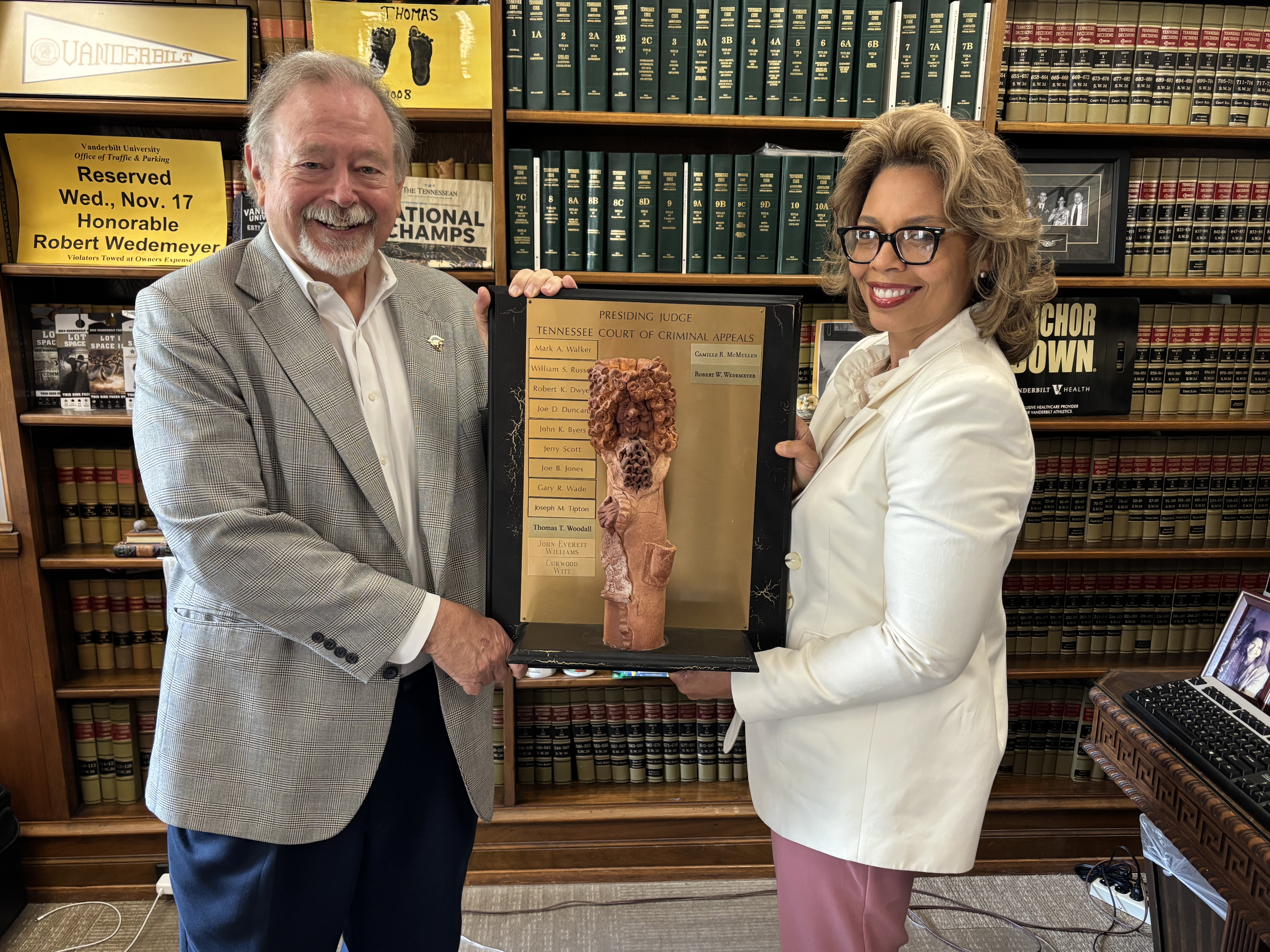 CCA Judges Robert Wedemeyer and Camille McMullen holding the presiding judge infinity/eternity plaque
