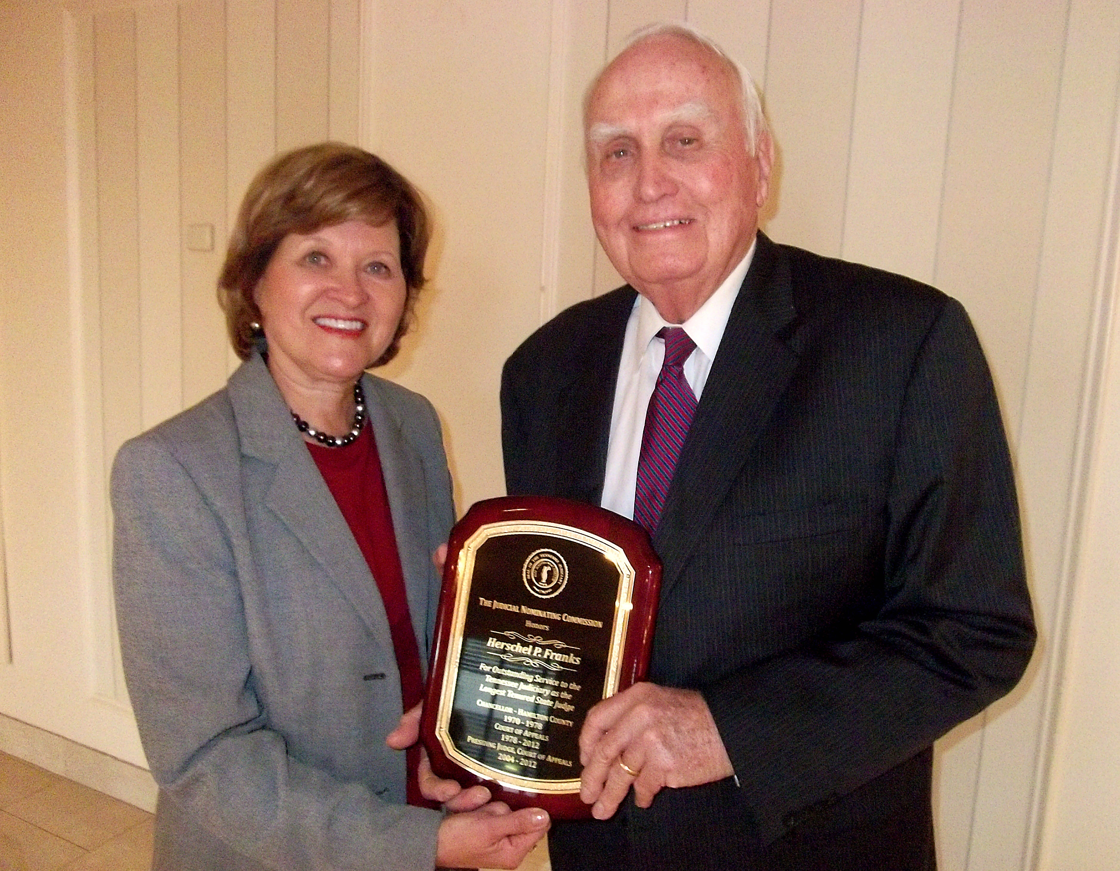 Supreme Court Justice Sharon G. Lee presents Judge Herschel P. Franks with a plaque commemorating his service as he prepares to retire at the end of the year.