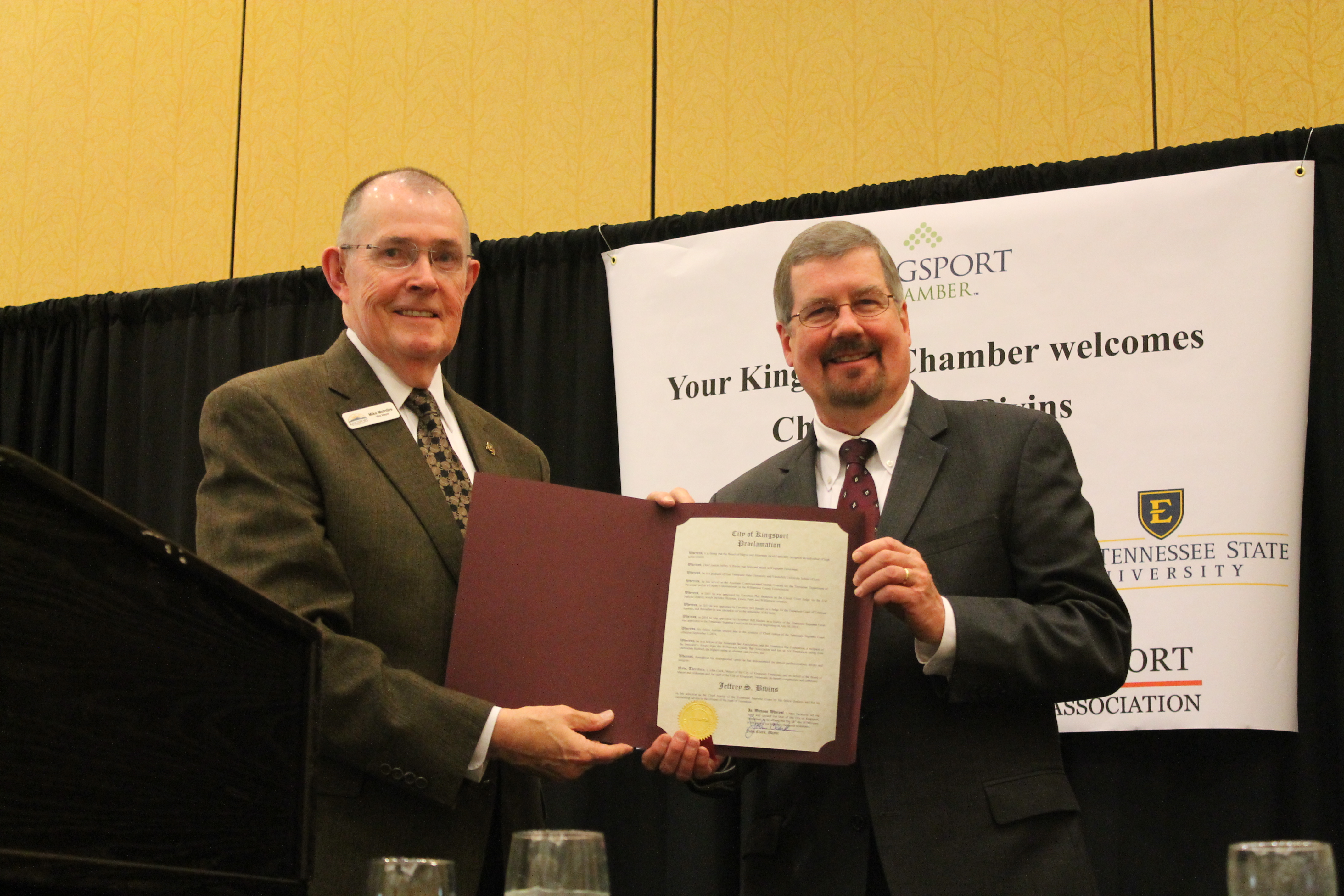Vice Mayor Mike McIntire presents Chief Justice Jeff Bivins with a Kingsport City Proclamation.