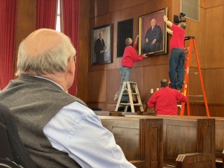 Judge Susano looks on as his portrait his hung in the Knoxville's Tennessee Supreme Court building